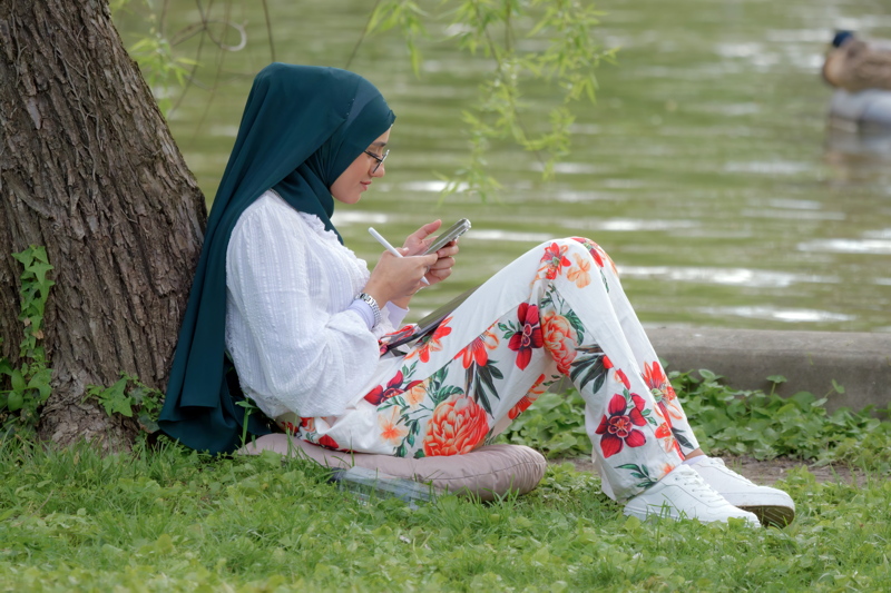 Young woman relaxin by a tree